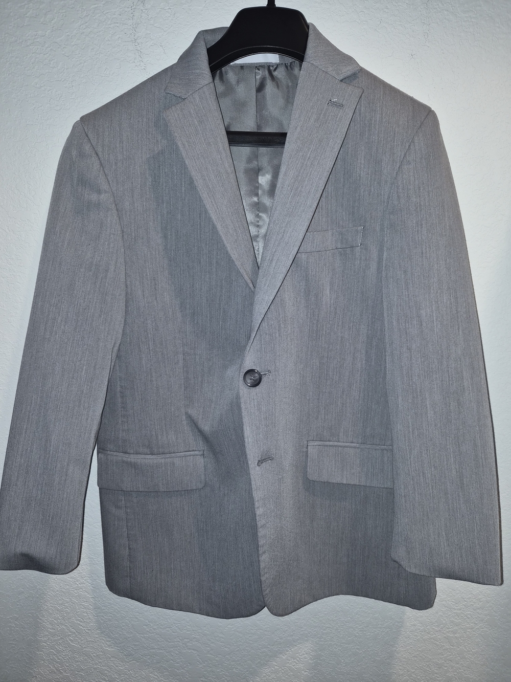 a child suit in a versatile light gray color with a light texture.